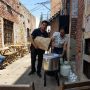 Robert and Zaida adding the grain